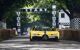 Yellow sports car driving down a road