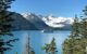 Cruise Ship on beautiful blue bay of water with snowy mountains in the background