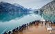 Cruise ship passengers standing on ship's prow looking at Glacier Bay National Park