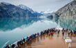 Cruise ship passengers standing on ship's prow looking at Glacier Bay National Park