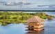 thatched house in the middle of the river