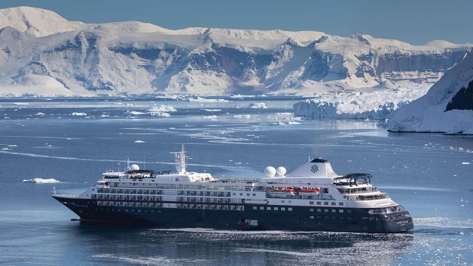 Cruise ship with icebergs behind