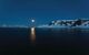 striking night view of bay with moon in background