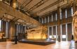 Interior of museum - a big empty room with a giant sarcophagus in the centre