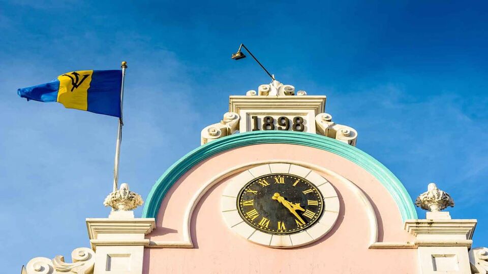 view of a clock on top of a building in colonial style