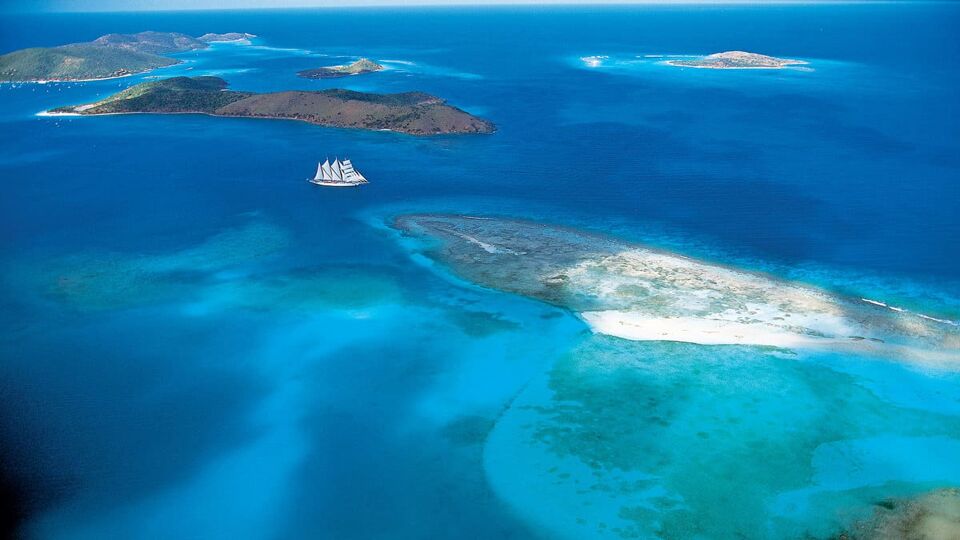 tiny cruise ship boat in a beautiful blue island landscape