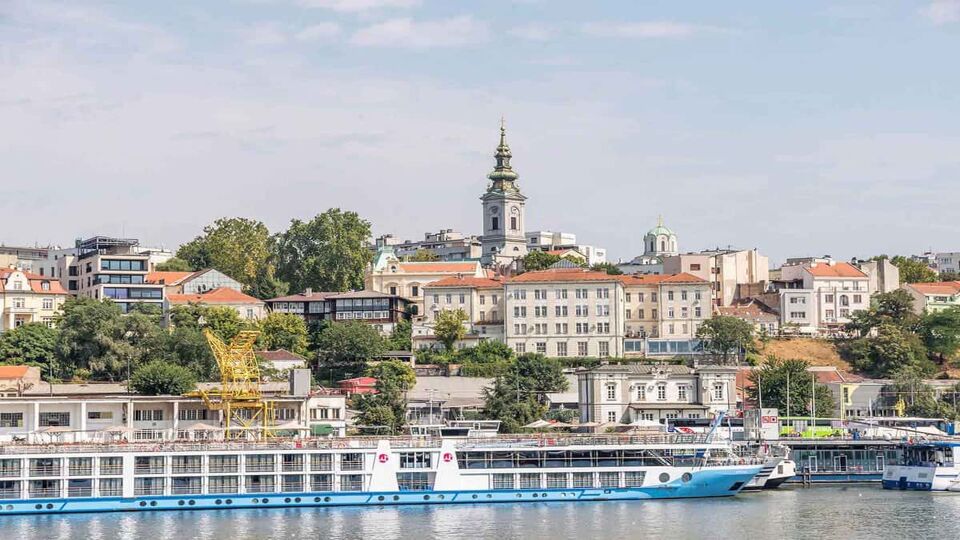 Cruise boat in front of Belgrade city architecture, near kalemegdan fortress.