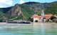 River cruising boat passing a small town