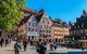 Tourists on the Tiergarten square in Nurnberg near Albrecht Durer house. Tiergartnerplatz at spring sunny day. Medieval european architecture.