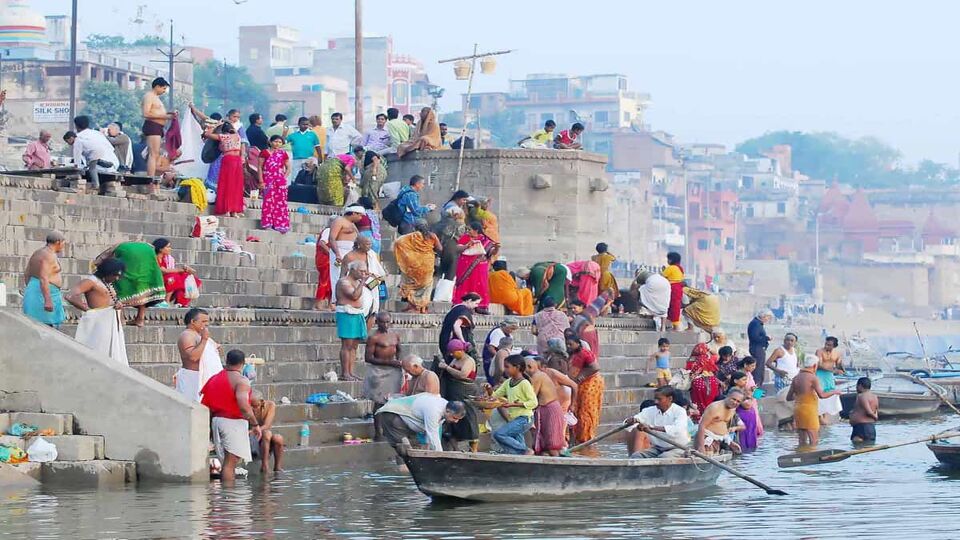 colorful Hindu people bathing in the Ganges river in Varanasi