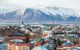 City view over rootops with snowy mountains behind