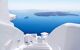 View through white walls to Santorini's caldera, with cruise ship in distance