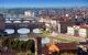 Aerial view down the river in centre of the city showing several bridges