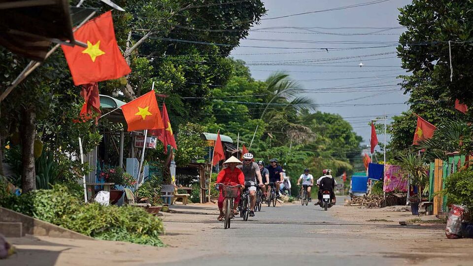 Tourists cycling through a small village in vietnam
