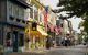 street view of a street with colourful old fashioned new england buildings