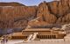 external view of the golden stone temple with mountains behind