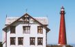 Lighthouse and white wooden old house in Norway traditional architecture norwegian culture Vesteralen islands