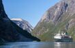 view of a cruise ship in a fjord from the water