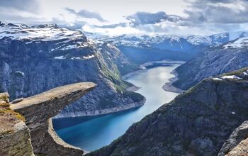 Small rock jutting out in front of a landscape of fjords