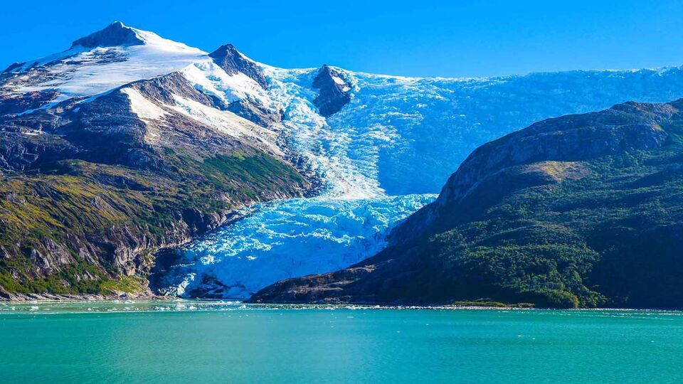 Giant glacier winding down cliffs