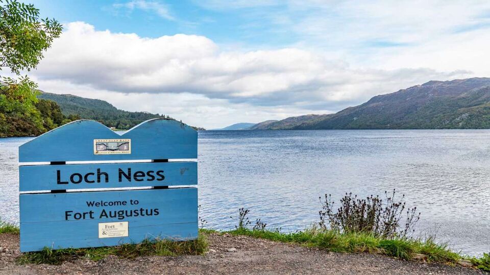 loch ness sign with the loch behind