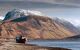 shipwreck with snow-capped mountain behind