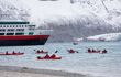 cruise passengers kayaking off the back of a cruise liner in the Svalbard archipelago