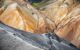 view of large sloping cliffs of unusually colourful rocks