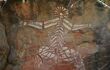 Close up of a white aboriginal painting of a god on a rock