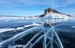 Lake Baikal frozen in winter. A group of tourists came on an excursion to the beautiful iced cape of Horin-Irgi or Cape Kobyliya Golova