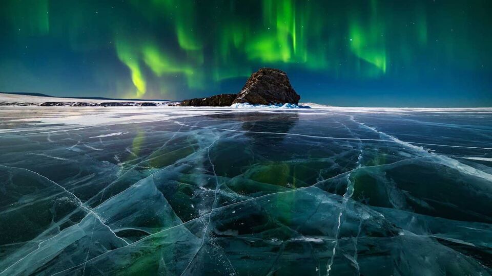 Aurora borealis over the ice of a frozen lake Baikal, Siberia, Russia