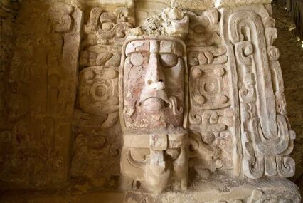 well preserved statue on the Temple of the Measks at Kohunlich maya archaeological site in Quintana Roo Mexico