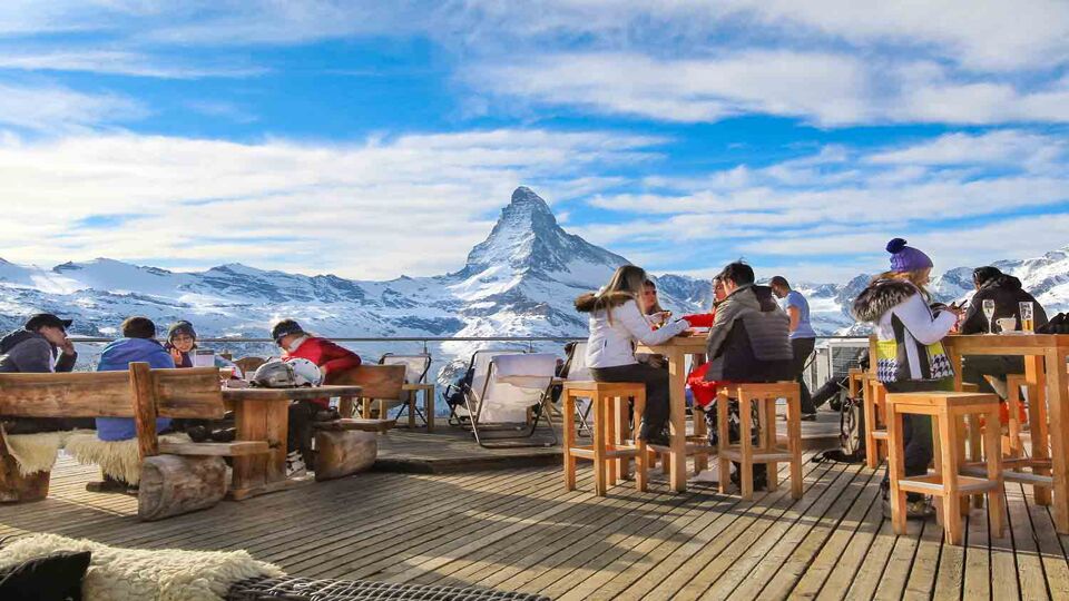 People sitting on terrace overlooking the Matterhorn